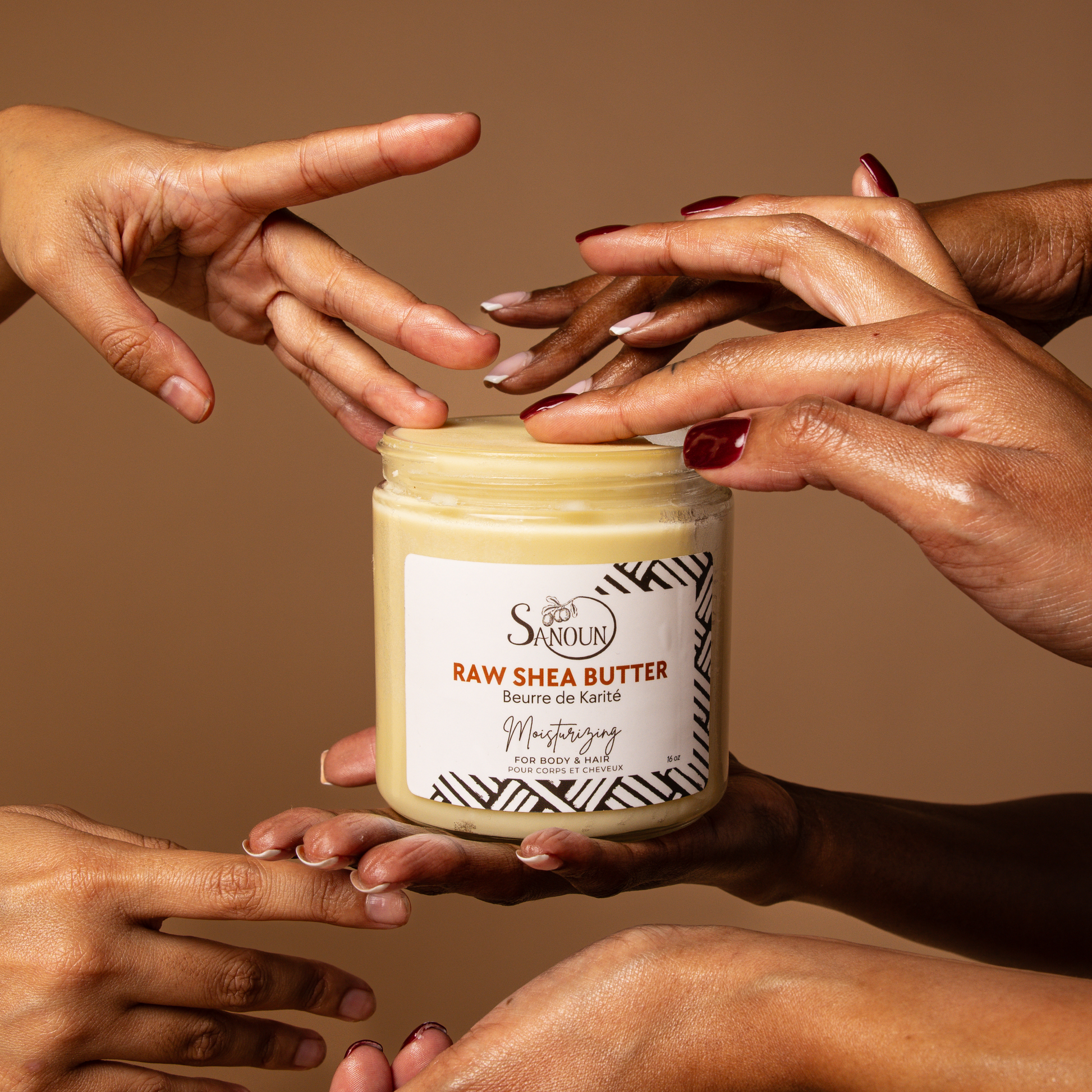 soft hands touching jar of raw shea butter