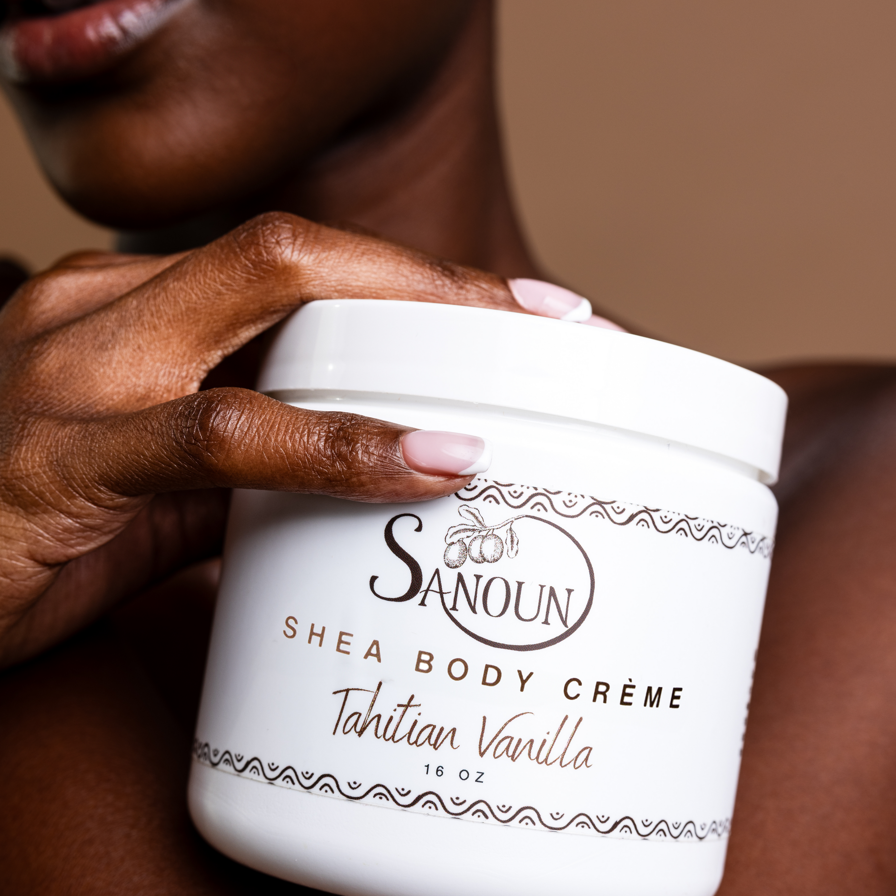 woman holding shea body creme jar
