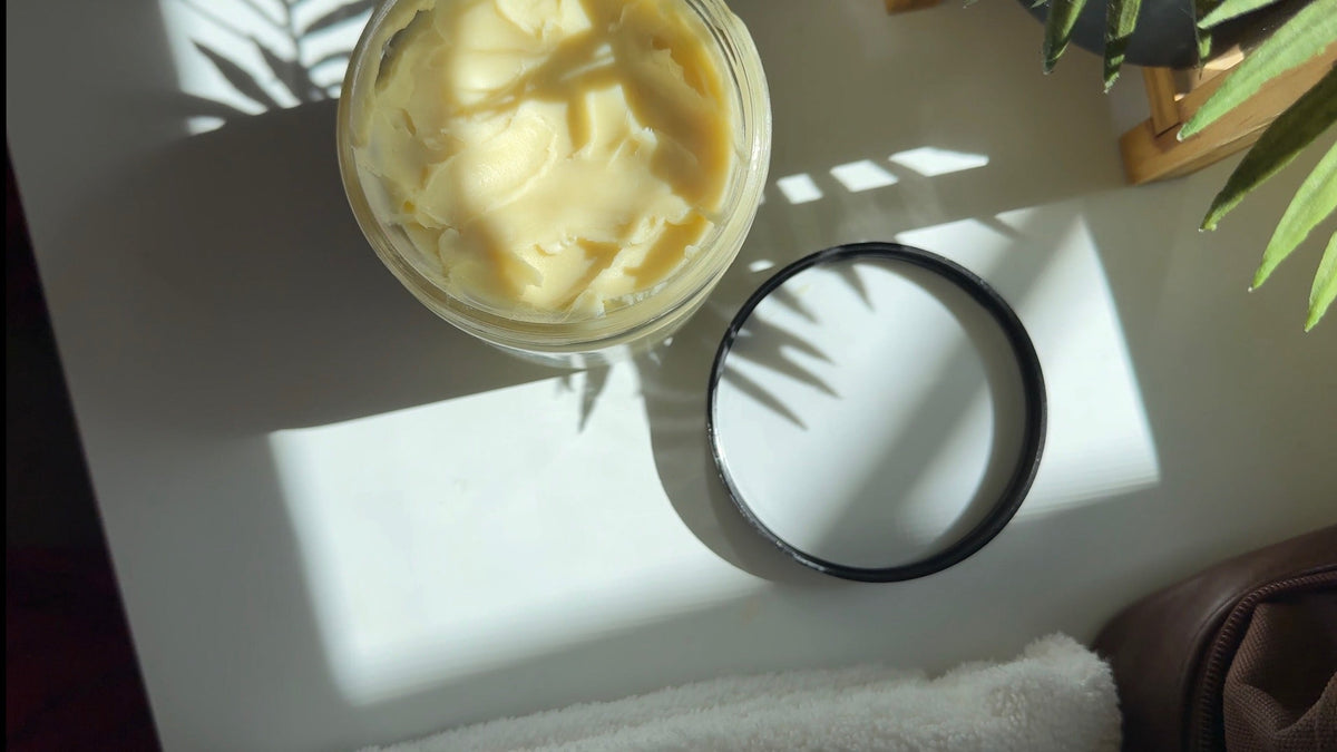 An open jar of unrefined shea butter from Bougouni, Mali, in morning light