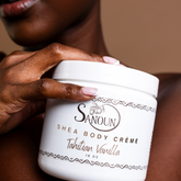 woman holding shea body creme jar