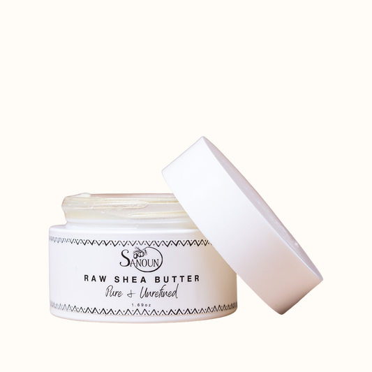 Mini Raw Shea Butter jar with lid off on cream background