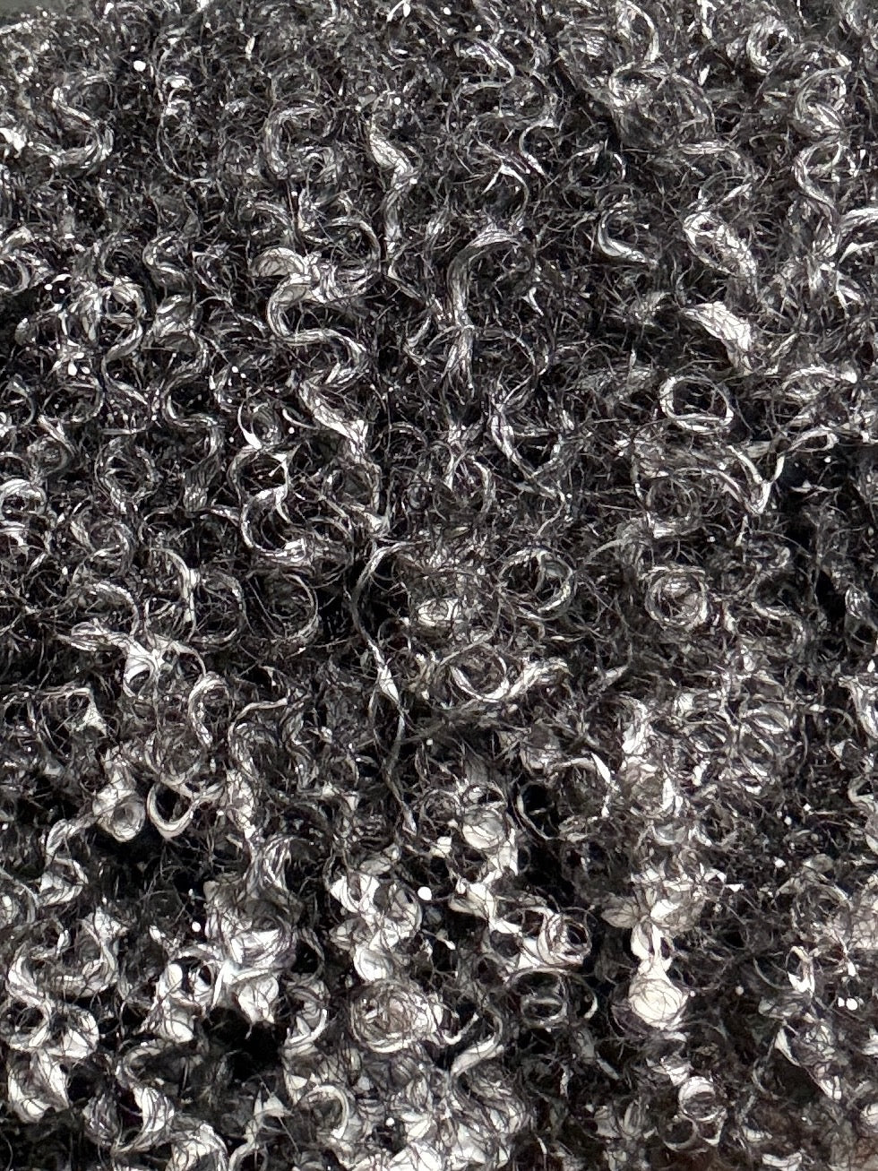 Close-up of moisturized natural curls with defined coils and shine