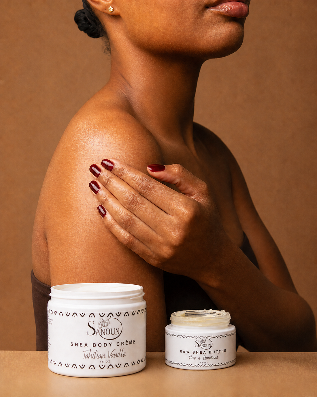 Woman pressing layered moisture into her shoulder with The Layering Ritual products